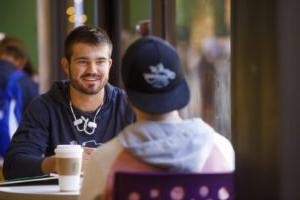 Photo of two Hardin-Simmons students chatting in a break room.